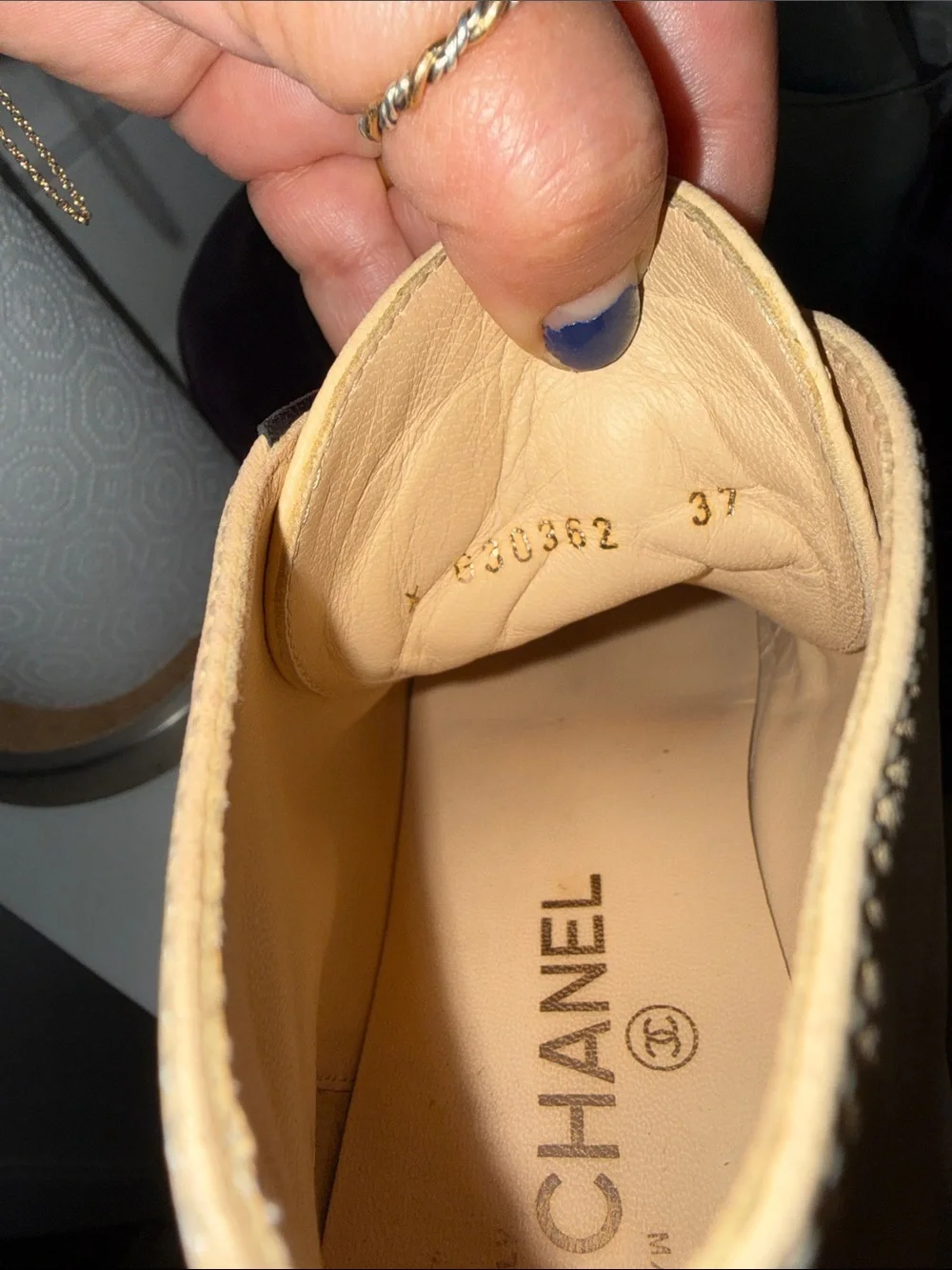 CHANEL Two-Tone Leather High-Top Sneakers in Beige & Black